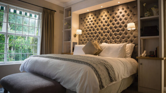 Illuminated neat bedroom at home